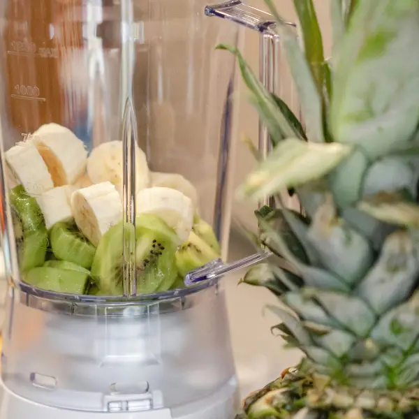Blended banana and kiwi during a milkshake bar event at a company