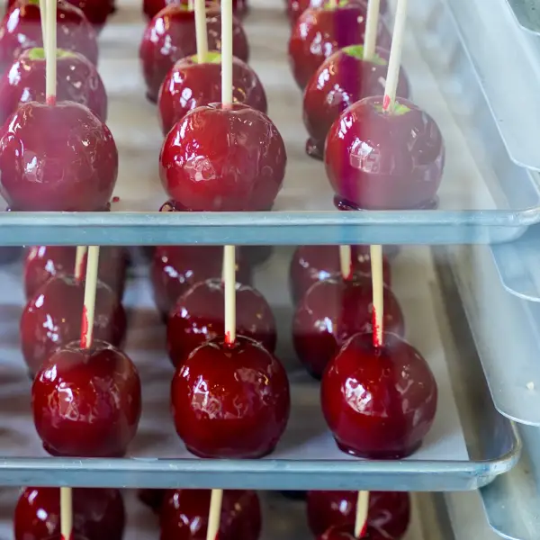 Candy apples on a rail during a candy apple event at a company